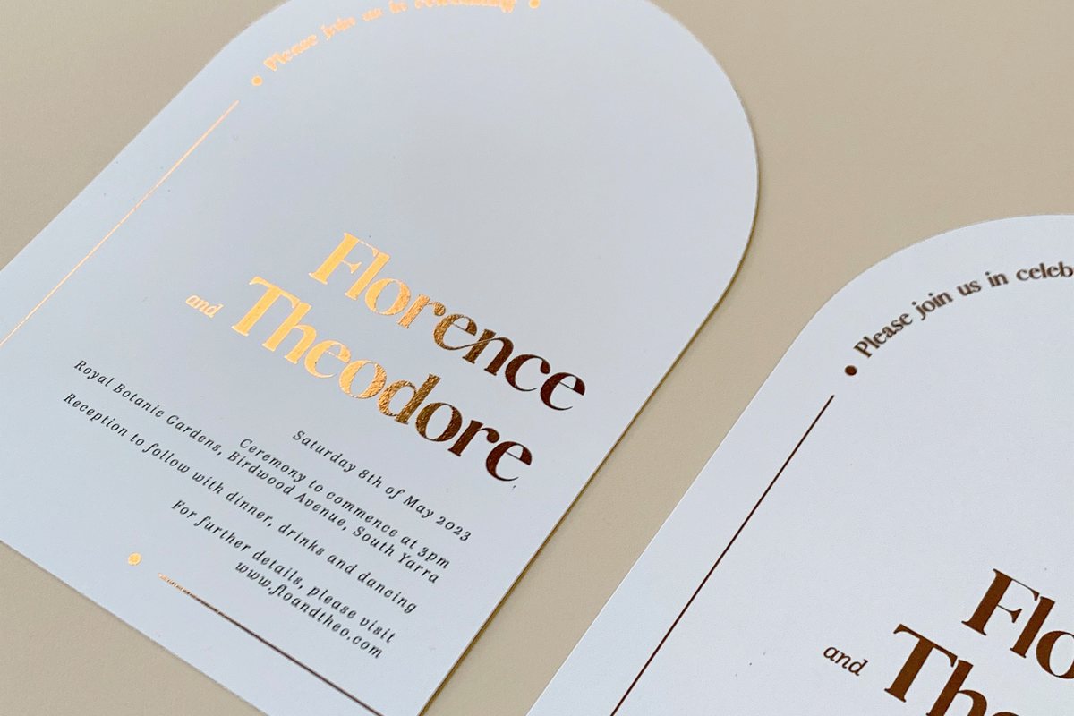A white arched card on beige shows flat foil in bold copper serif letters and black italic text.